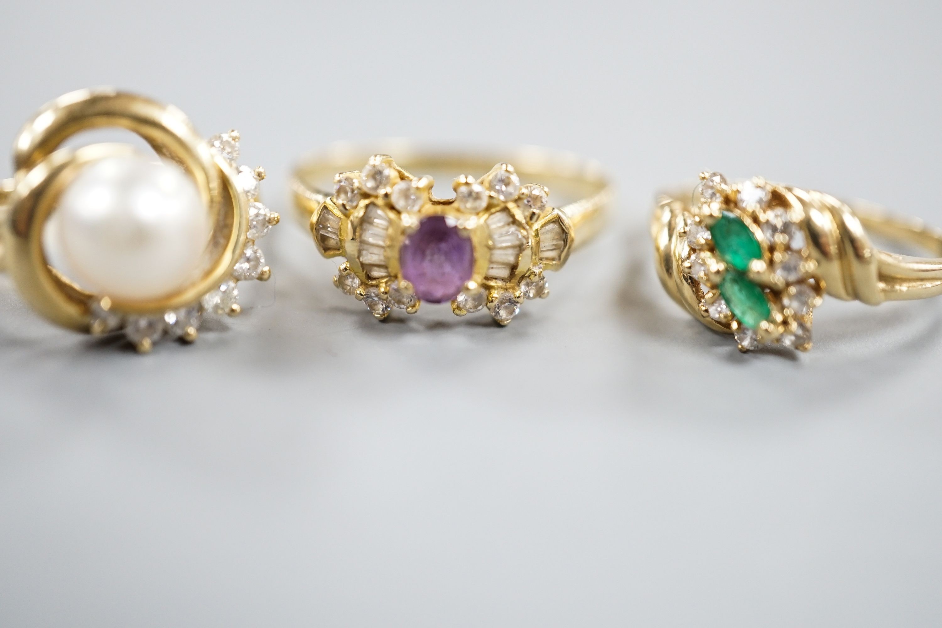 Three assorted modern 14k yellow metal and gem set dress rings, including cultured pearl and diamond, gross weight 10 grams.